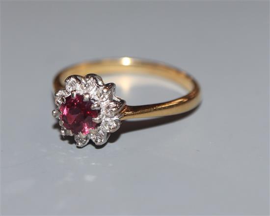 An 18ct, ruby and diamond cluster ring, size N.